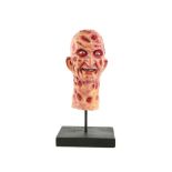 Freddy Kruger from A Nightmare on Elm Street, a mini latex maquette of his head on stand, 15 cm