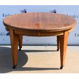 19th century mahogany circular extending table, inlaid tapered legs on castors, 73cm high, 122cm