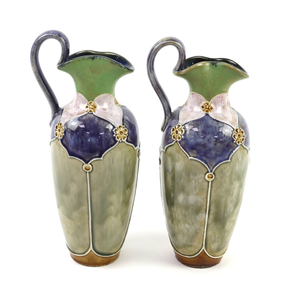 Pair of Royal Doulton jugs by Florrie Jones, 23cm high. One jug has a 3.5 cm firing crack to the rim - Image 2 of 4