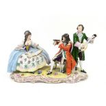 20th century Dresden figural group of a seated woman and two musicians.