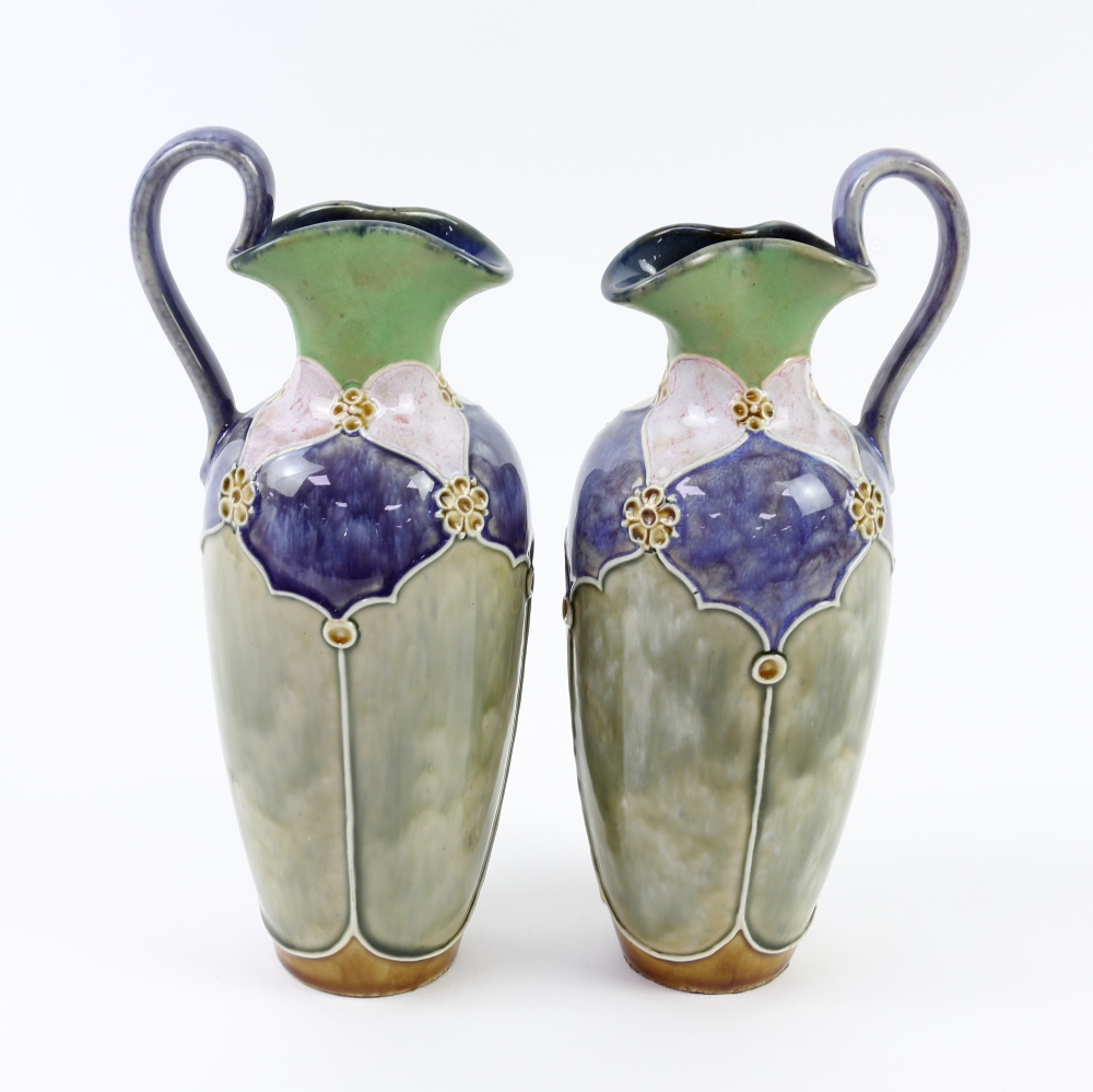 Pair of Royal Doulton jugs by Florrie Jones, 23cm high. One jug has a 3.5 cm firing crack to the rim - Image 3 of 4