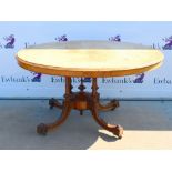 19th century walnut table, the quarter veneered oval top above turned supports and quadriform base