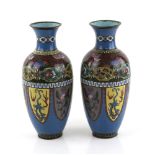 A pair of Japanese cloisonné enamel vases; each one with typical lappet-shaped motifs, bands of