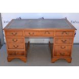 20th century yew veneered pedestal desk, with an arrangement of nine drawers on bracket supports, 77
