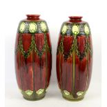 A pair of Minton Secessionist vases No. 1 circa 1910 in red with tube lined swags in green (