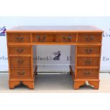 20th century yew wood veneer pedestal desk, with one long and two short drawers above an arrangement