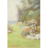 Lilian Stannard (British 1877-1944), Path through a garden with flower borders, signed, watercolour,