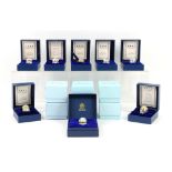 Collection of ten boxed Halcyon Days enamel miniature Easter eggs, with holders.