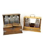 Oak three bottle tantalus with hinged lid revealing fitted interior, 32 x 35 x 25cm, and another oak