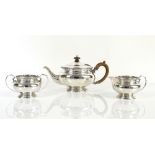 George V silver three-piece tea service, the teapot and cream jug by Stewart Dawson & Co Ltd, London