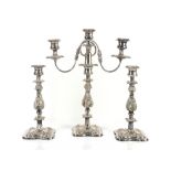 Silver plated three light candelabra and a pair of matching candlesticks with moulded decoration,