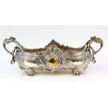 Large silver-plated centre-piece, the shaped oval body on four scroll feet, with twin handles, 46.