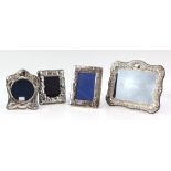 Four modern silver-mounted frames including two decorated with children's toys, one larger frame