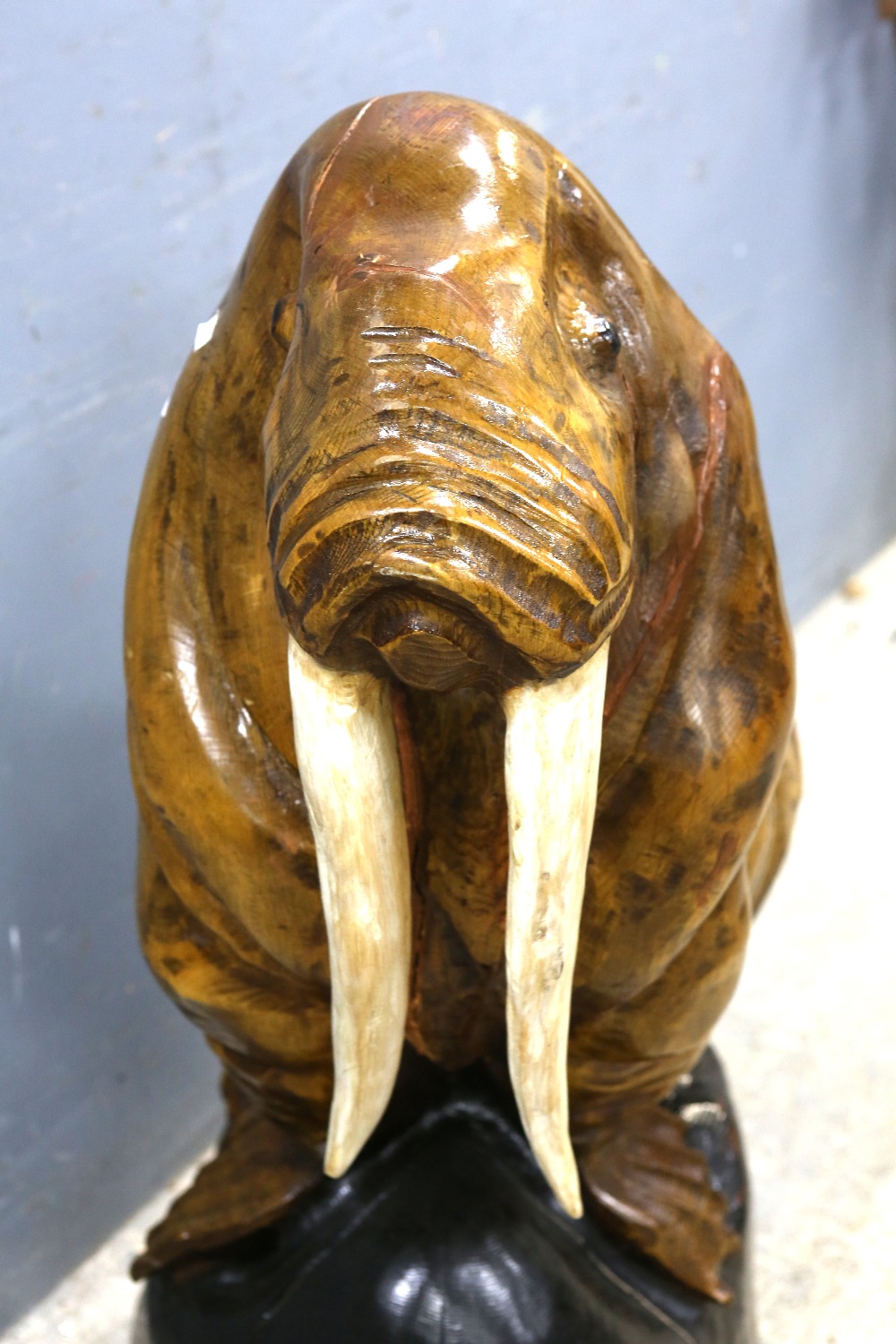 A large wooden carving of a walrus, H.114cm Large cracks to body and base. Evidence of repair to one - Image 2 of 2