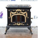 Wrought iron wood burning stove by Hunter & Son (Mells) Ltd, Somerset England, in black with gilt