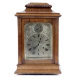 A German oak cased mantle clock by Gustav Becker, with silvered Roman dial, having chiming gong, H.