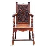 Victorian oak armchair, the backrest carved with animals and commemorating Queen Victoria’s