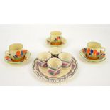 Three Clarice Cliff coffee cans and saucers and the Devon pottery egg cup stand Sold on Behalf of