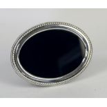 R Carr silver photo frame of oval form with a rope edge border, Sheffield 1987 16 cm Diameter. See
