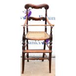 19th century child's high chair, with scrolling top rail above caned seat and turned supports on