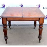 19th century mahogany dining table, with gadrooned legs on castors, H74 x W104 x D104cm Damage to