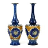 Pair of Royal Doulton early 20th century vases with heart and flower decoration on a cobalt