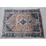 Antique Kazakh orange ground rug, central diamond medallion on a orange ground with repeating