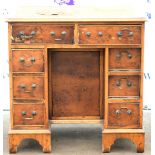 Walnut kneehole desk, with leather writing surface above eight drawers on bracket feet, H76 x W76