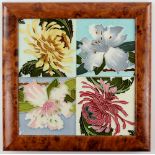 Group of four tiles with tube lined floral decoration, framed as one, each tile approximately 15 x
