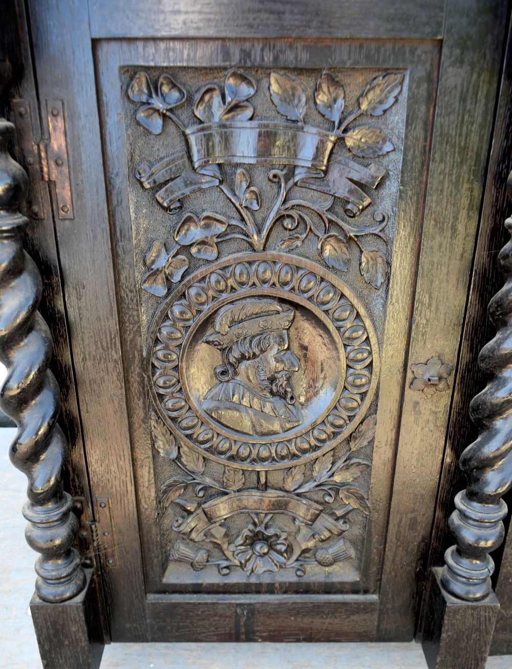 20th century oak cabinet, two cupboard doors carved with flowers and busts, having barley twist - Image 2 of 3