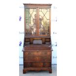 George III style mahogany veneer secretaire bookcase, bearing label for 'Maple', dentil cornice