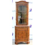 Reproduction burr walnut veneer corner cabinet, glazed door above cupboard door on bracket feet,