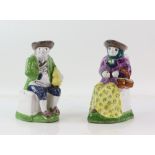 Pair of Toby jugs, comprising a seated woman with basket on her arm and another of a seated man,