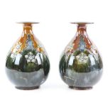 Royal Doulton stoneware pair of vases, in blue and brown glaze with floral decoration, impressed