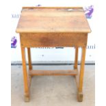 Vintage oak school desk, the hinged top with ceramic inkwell marked 'Bennet Furnishing Co. Ltd,