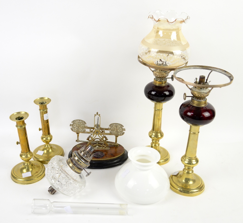 Pair of Victorian brass stemmed oil lamps with ruby glass well, h35cm, and a pair of brass