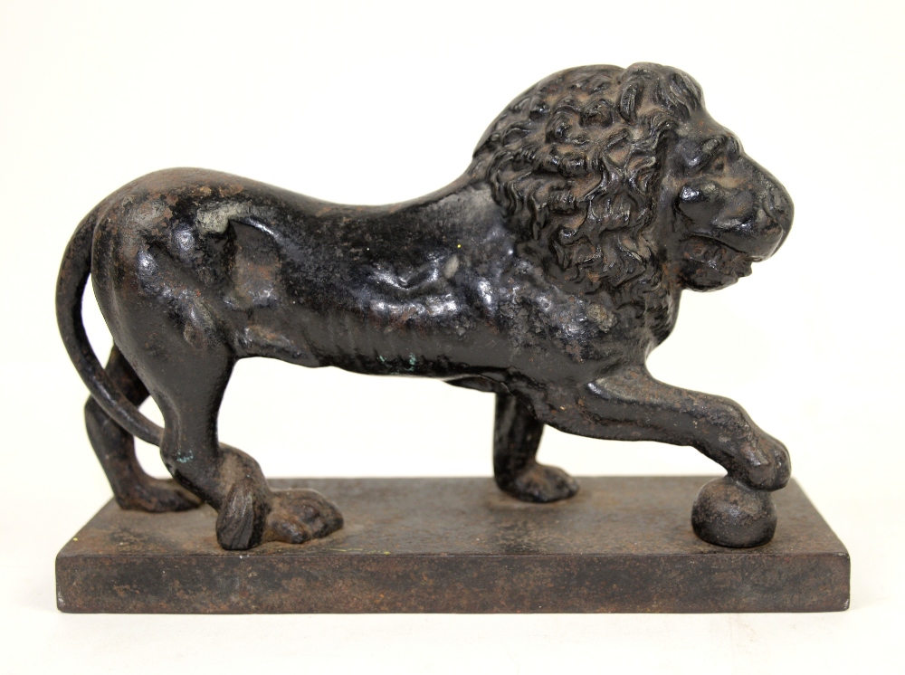 Victorian cast iron doorstop in the form of a lion with a paw on a ball Condition: heavily worn,