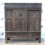 19th century Indian carved hardwood cupboard with sliding panelled door enclosing shelves on
