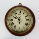 Early 20th century brass ship's bulkhead clock, the round dial with Roman numerals and outer