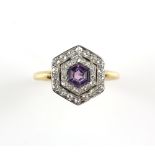 Early 20th C amethyst and diamond target ring featuring a hexagonal cut amethyst with two old cut