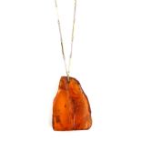 Amber asymmetric triangular form pendant, with white sapphire set bale, on a two-tone bar link 9
