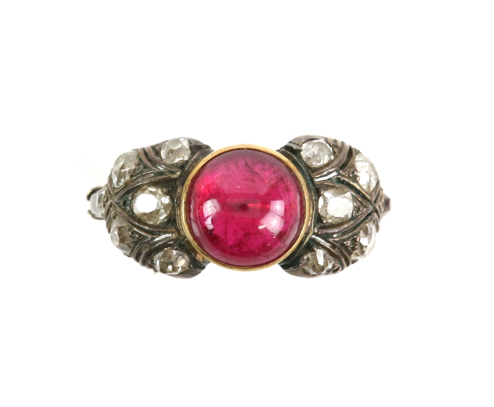 Old cut diamond and synthetic ruby ring; featuring a central circular cabochon cut synthetic ruby,