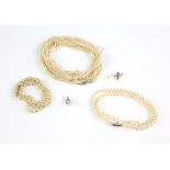 Opera length multi-strand seed pearl necklace, rose cut diamond set clasp testing as 18 ct or