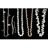 Four pearl necklaces including an abstract design necklace, a pearl and pink quartz necklace, a