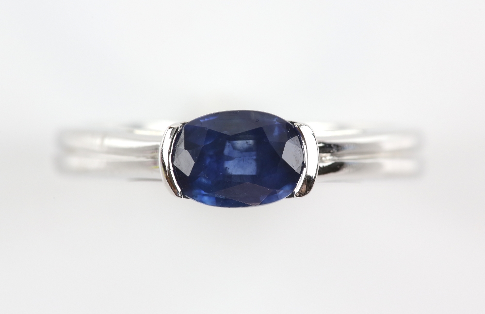 Contemporary sapphire ring, oval cut sapphire, estimated weight 0.90 carats, mount stamped 18 ct,