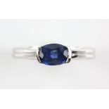 Contemporary sapphire ring, oval cut sapphire, estimated weight 0.90 carats, mount stamped 18 ct,