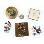 Three vintage compacts, an enamel floral button and a selection of loose stones, including oval