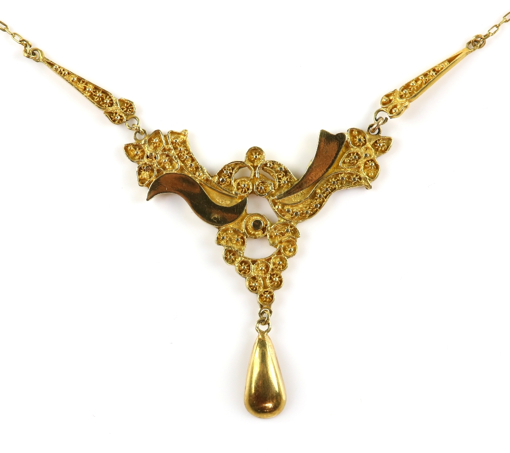 Continental necklace of symmetrical form, carved decoration in relief, with drop, testing as 14 ct