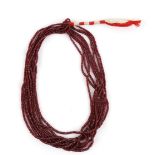 Eight strand ruby bead necklace, comprising of graduated faceted ruby beads, 41cm long, on plaited