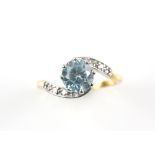 Zircon and diamond twist ring, central round cut blue zircon, estimated weight 2.39 carats, Swiss